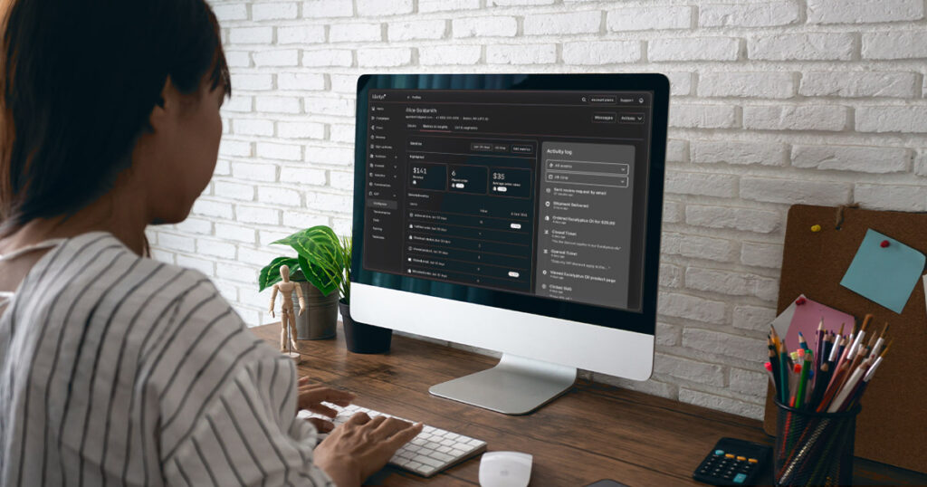 A woman sits in front of her computer to tackle her email marketing objectives.